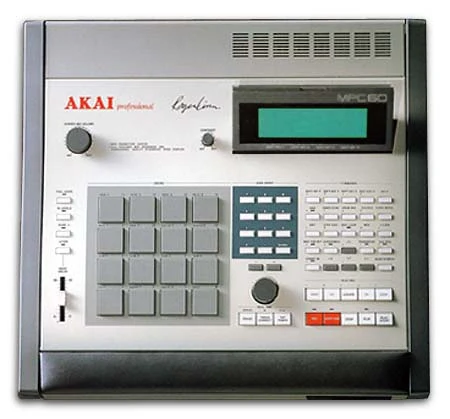 Akai MPC60 seen from above, with a four-by-four grid of grey pads on the left, a numeric keypad and data wheel in the centre, and a backlit display carrying Roger Linn’s signature.