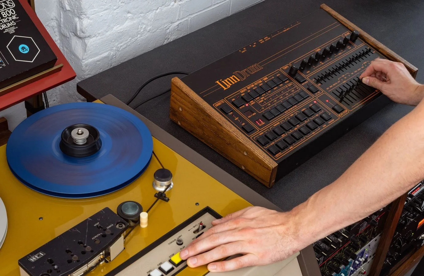 Lindrum From Mars recording session: a hand on the faders of an original LinnDrum, recorded to tape, with a turntable beside it.