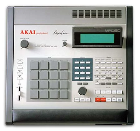 Akai MPC60 with Roger Linn’s signature printed next to the Akai Professional logo, a four-by-four grid of grey pads on the left, a large LCD at the top right and transport buttons below it.