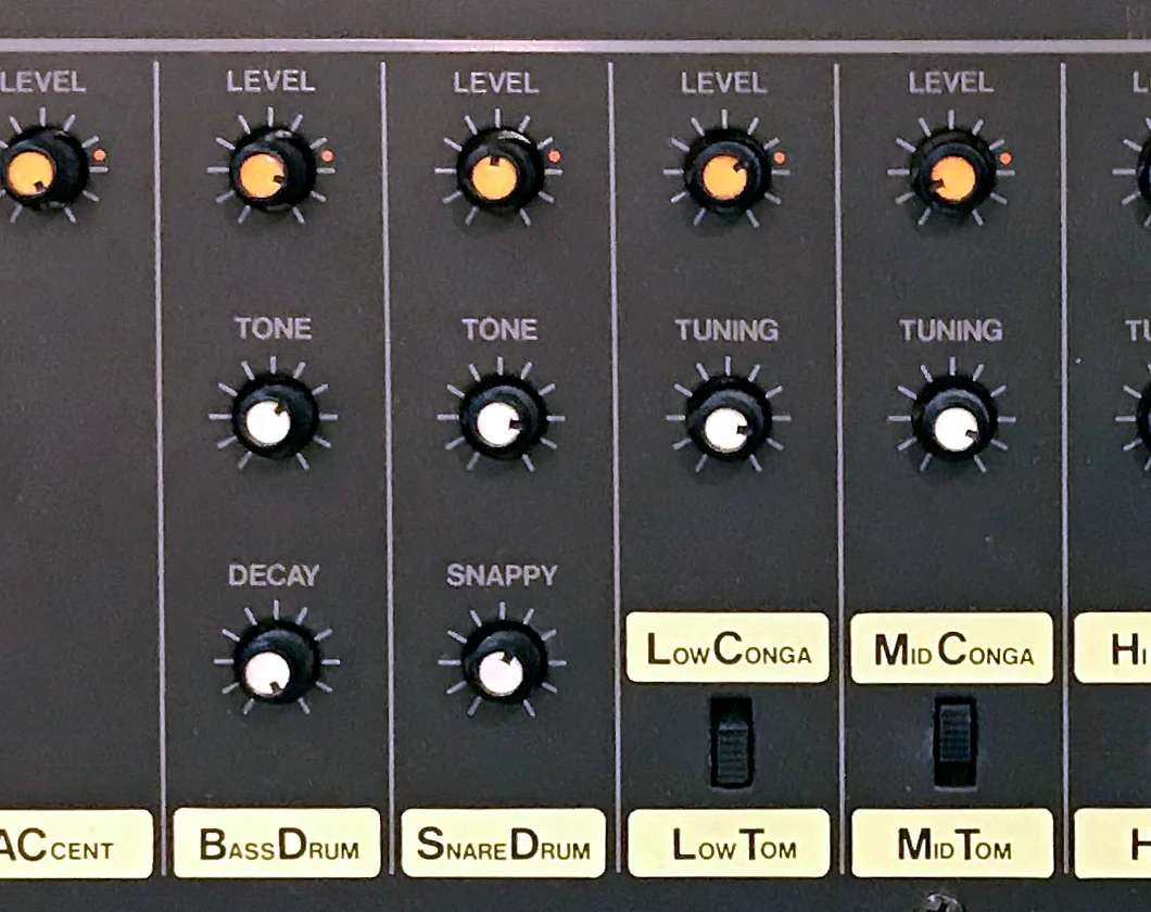 Close-up of the TR-808 panel. The Bass Drum column has only Level, Tone and Decay knobs, while the conga and tom columns next to it each have a Tuning knob.